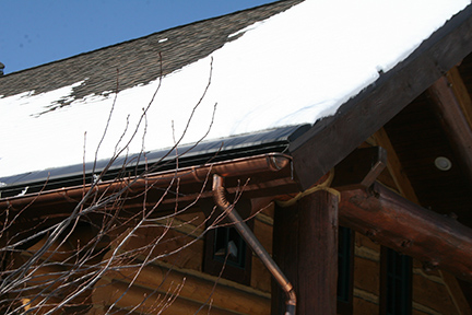 This snow covered shingle roof can benefit from the addition of SnoFree™ 12” eave roof panels.