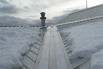 An example of the SnoFree™ 4” or 6” Existing Valley Panel installed on a metal roof.